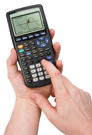 A hand using a TI-83 calculator against a white background; iStock.com