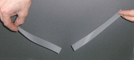 Two pieces of tape with like charge repel each other.