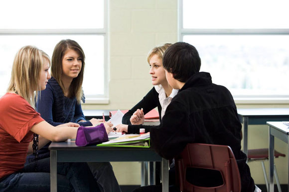 students sitting in a classroom having a discussion