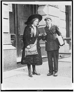 woman distributing a pamphlet to a man  in the early 1900s New York