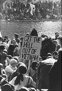 group of students protesting the Vietnam War with one man holding a sign that says 'Get the Hell out of Vietnam'