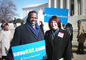 two supporters of Roe v Wade hold signs in support of abortion rights on the steps of the Supreme Court