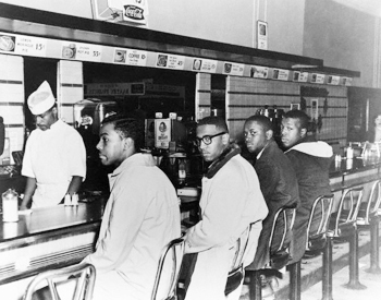 African American men sitting at a lunch counter in Greensboro, NC