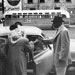 African Americans entering a car; an empty bus is in the background