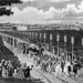 Crowd of workers with factory in the background