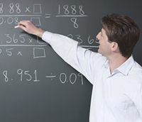 Teacher writing on chalkboard