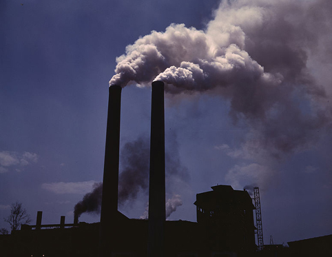 smoke coming out of a factory smokestack