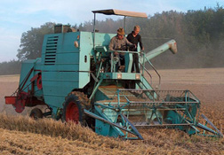 a combine harvester in an agricultural field