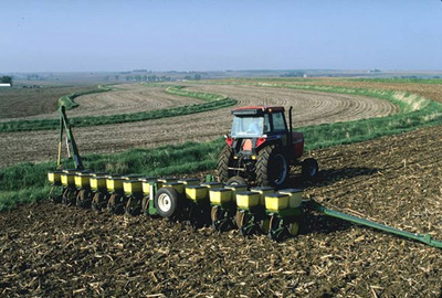 farm machinery placing seeds in the ground