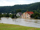 homes partially submerged under flood waters