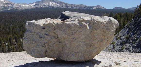 a large boulder in the landscape