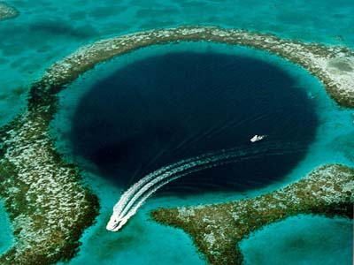 Aerial view of a large water-filled sinkhole