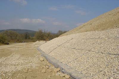 cages filled with rocks and placed against a sloped landscape to prevent erosion