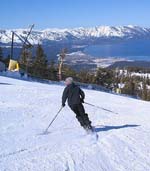 an alpine skier with trails in the snow formed by the skis