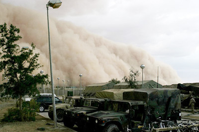 a huge cloud of dust traveling over the landscape