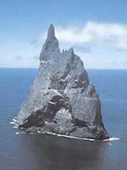 a large rock sticking out of the sea