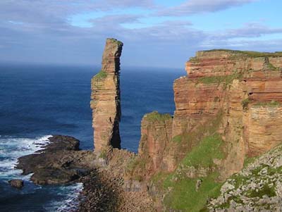 a tall tower of rock along a shoreline