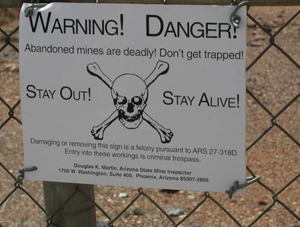 a sign warning people to stay out of an abandoned mine area