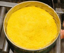 a barrel with bright yellow powder in it