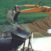 a excavator extracting materials from a large hole