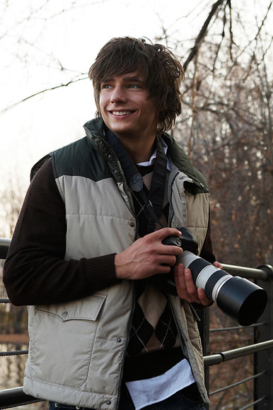 A teen boy taking photos.