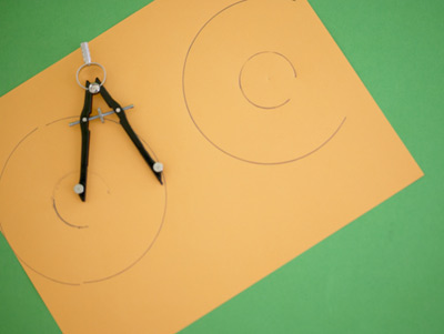 Circles drawn by a compass, with compass lying on paper