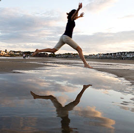 Health: Mental and Emotional Health, Person leaping on a beach