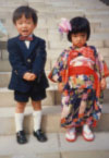 Japanese children dressed in formal attire and kimono