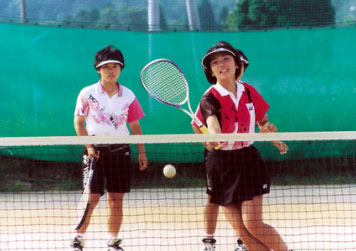 two girls playing tennis