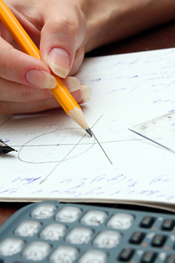 A student graphing a math equation; Shutterstock.com