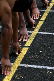 Hands on starting line; Shutterstock.com