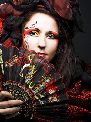 Young woman in hispanic style with fan; Shutterstock.com
