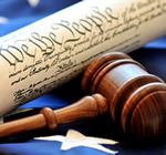 Close-up of gavel with the U.S. Constitution and Flag in the background; Shutterstock.com