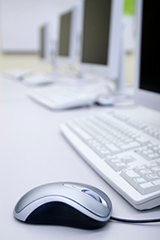 Computer mouse and a row of monitors; Shutterstock.com