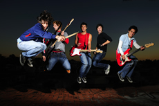 A rock-n-roll band playing instruments; Shutterstock.com