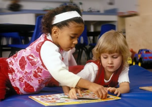 Two young children learning together.