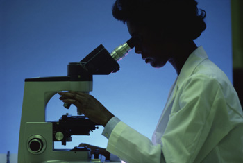 Scientist looking through a microscope