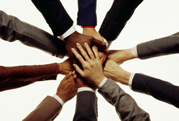 Group of hands clasped in teamwork