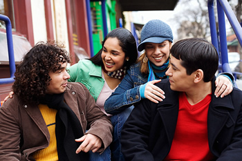 Group of young people talking outside and feeling happy hanging out with one another