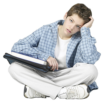 Stressed-out teen with notebook on his lap