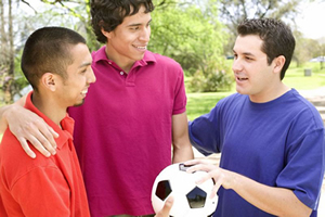 Three teen boys with a soccer ball