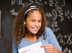 Smiling teen girl holding an 'A' graded paper.