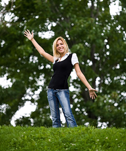 Young woman happy in a natural setting with trees