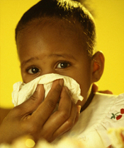 Sick girl blowing her nose